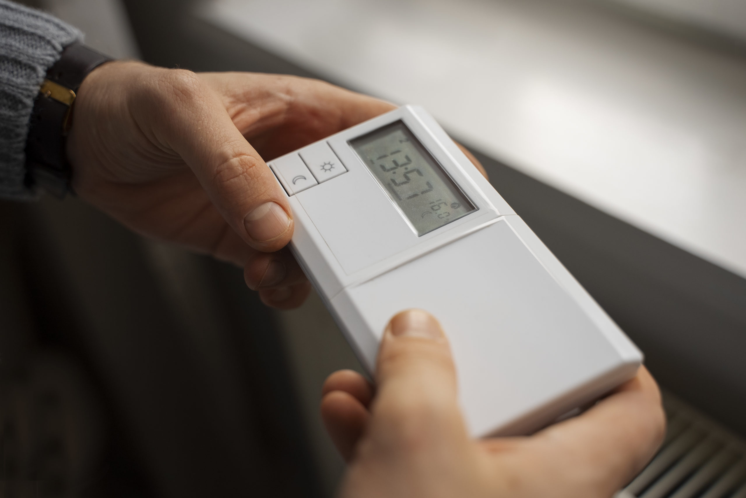 man-turning-off-thermostat-energy-crisis